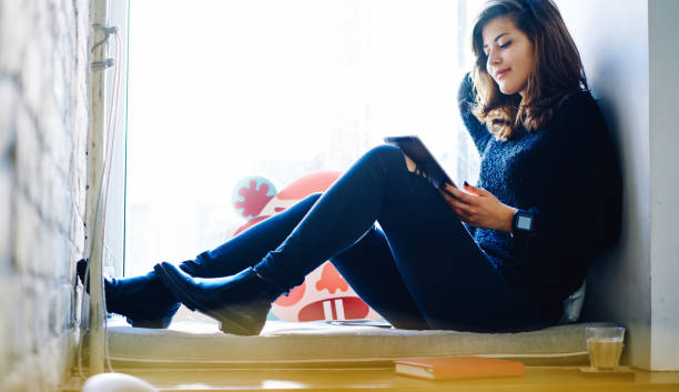 istock Young woman sitting in cafe with tablet 1466423316
