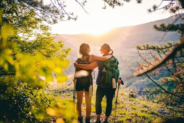 istock Mother and daughter hikers embracing each other 1466424520
