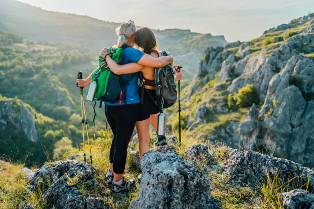 istock Mother and daughter standing on a mountain top 1466424811