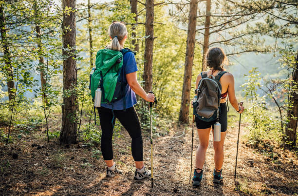 istock Mother and daughter hikers exploring woods 1466426141