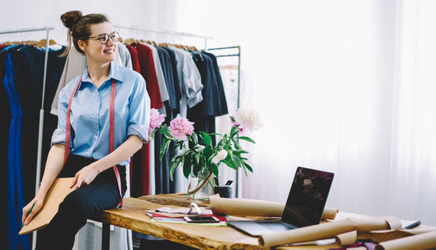 istock Cheerful woman with folder and measuring tape in workshop 1466426203