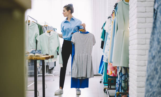 istock Concentrated woman picking clothes in atelier 1466426217
