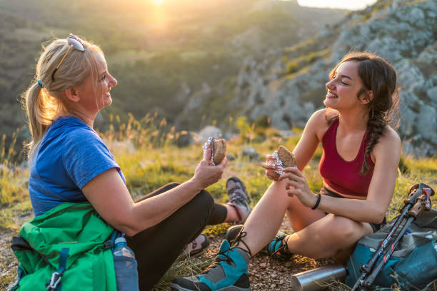 Mother and daughter hikers taking a break