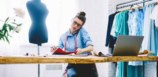 istock Serious woman talking on phone in atelier 1466426575