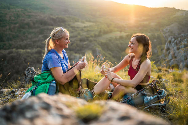 istock Mother and daughter hikers taking a break 1466426621