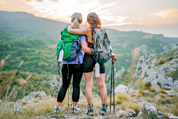 istock Mother and daughter standing on a mountain top 1466426728