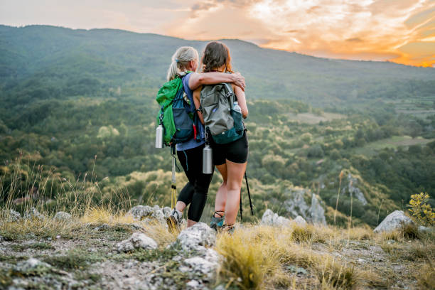 istock Mother and daughter standing on a mountain top 1466426870