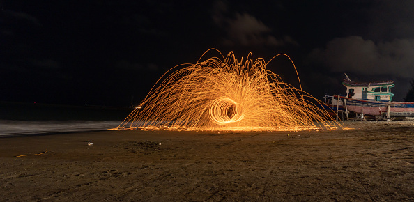 low angle light painting by burning steelwool