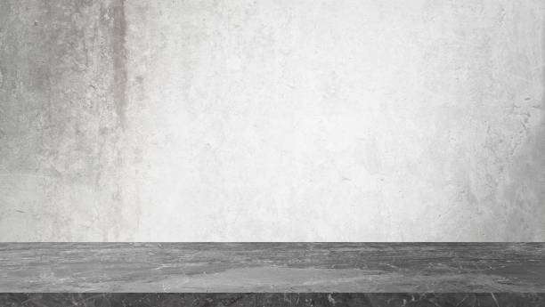 istock grey marble table in front of rusty grey concrete wall background with lighting from above. panoramic banner mockup for advertising and product displayed. indutrial interior concept for loft design. 1466427786