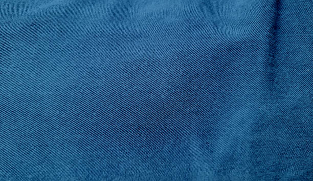 istock background of blue jeans denim fabric texture with black space for design, close up view. indigo denim background of rough cloth. 1466428301