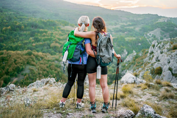 istock Mother and daughter standing on a mountain top 1466428340