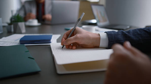 istock Businessman hands writing paper filling document application on office meeting. 1466428646