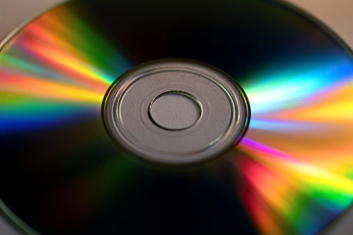 macro view of the entire surface of a compact disk, illuminated by the sunlight creates the light spectrum effect, with all color variations