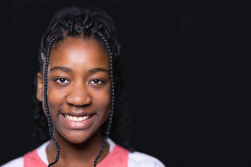 Portrait of a pretty young black girl with braided hair.