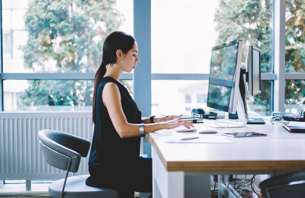 istock Serious businesswoman working on computer in light workspace 1466431828