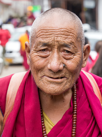 Dharamsala, India - sep 25, 2014 : Old unidentified Tibetan Buddhist monk in the Dharamsala near Dalai Lama's residence.