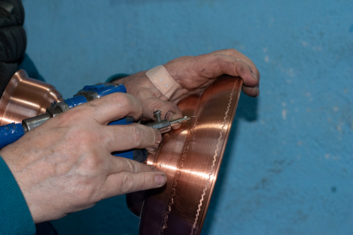 Coppersmith is working in his shop in Suleymaniye, Istanbul. Copper working in Suleymaniye is a traditional craft and dates back to several hundreds years ago.