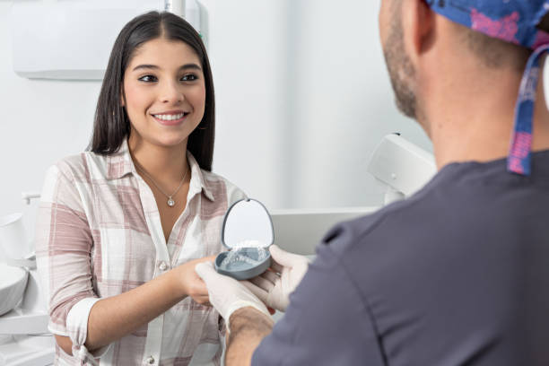 istock Cheerful teenager taking retainers from dentist 1466443674
