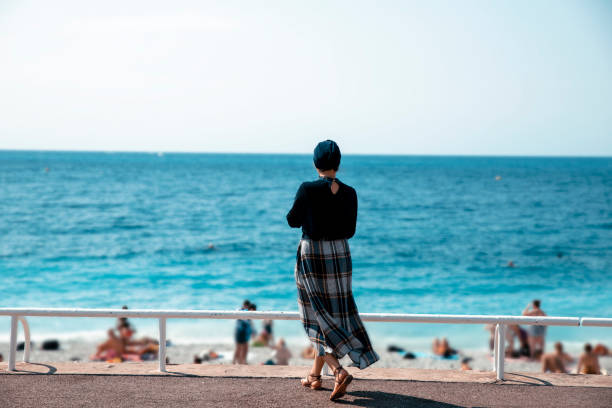 Low angle view of a mature woman jogging on a beach.