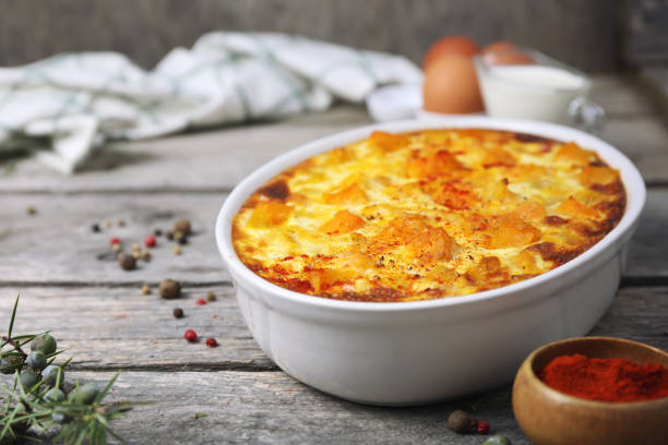 istock French cuisine. Vegetable pumpkin clafoutis in ceramic bakeware, smoked paprika dressing, eggs and cream 1466452491