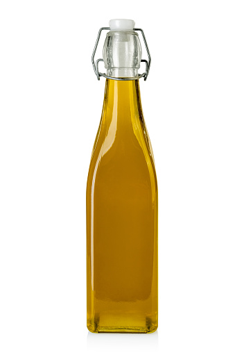 Extra virgin olive oil in glass bottle with airtight cap with snap closure isolated on white, clipping path
