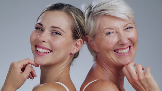 Skincare, beauty and face of women in a studio for a cosmetic, natural facial treatment. Cosmetics, happy and portrait of female models from Australia with a skin routine isolated by gray background.