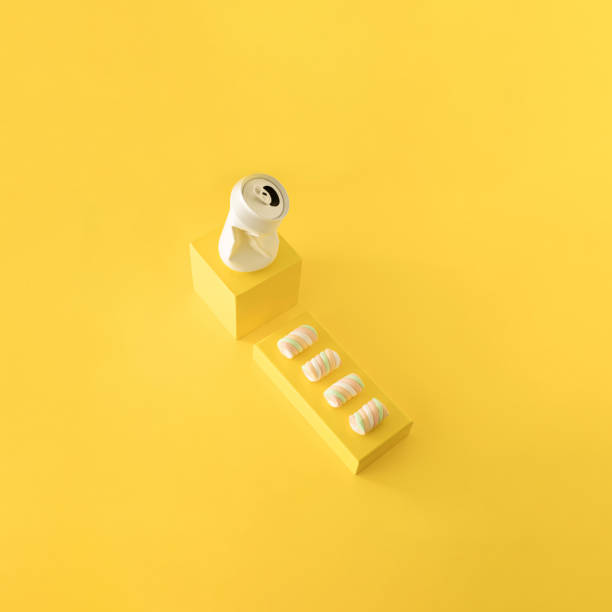 istock Colorful marshmallows and white crushed soda can on yellow background. 1466456989