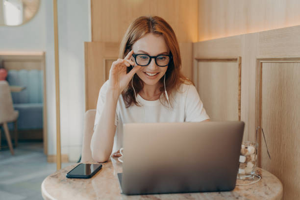 istock Woman remote worker looks in laptop screen 1466463132