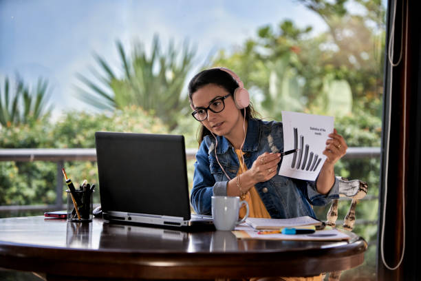 istock Hispanic young woman teaching remotely at home office using laptop computer 1466463270