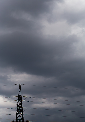 Power transmission pylon against a cloudy sky