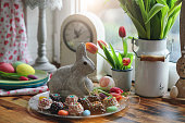 Decorating Easter Bunny Lamb Cake with Icing in Domestic Kitchen