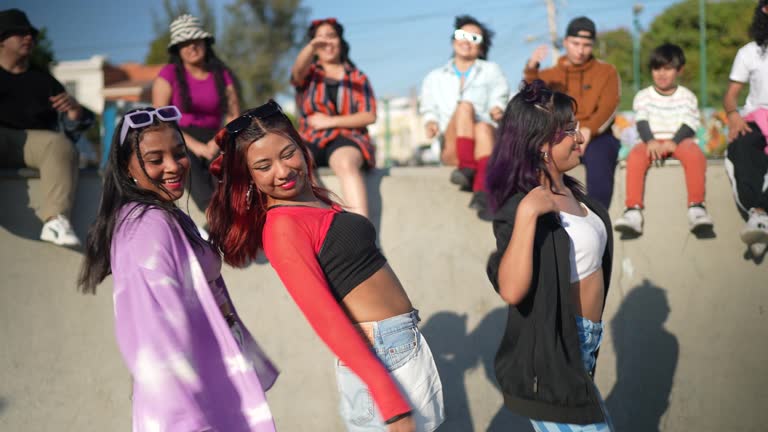 Friends dancing and having fun during street party at skateboard park