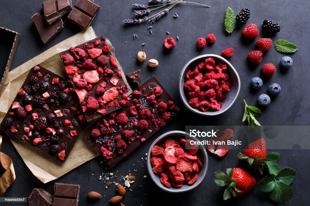Handmade chocolate with lyophilized berry fruits Artisan chocolates with different dried fruits,seeds and herbs Chocolate Stock Photo