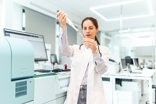 Beautiful Female Scientist Using Micro Pipette for Test Analysis