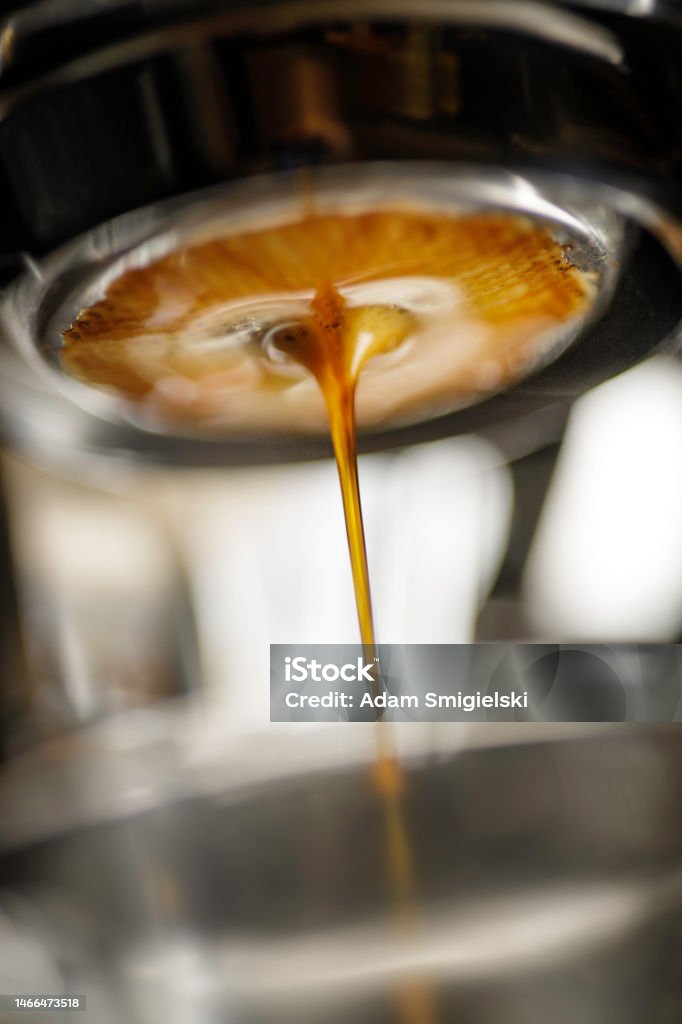 espresso being poured from a coffee machine making coffee with a professional espresso machine Coffee - Drink Stock Photo