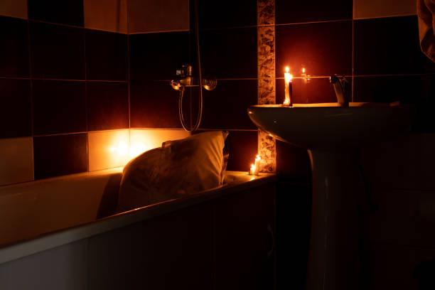 istock Bathroom as a shelter from rocket attacks in Ukraine by candlelight with a bed in the bathroom without light, war, sleeping in the bathroom 2023 1466477523
