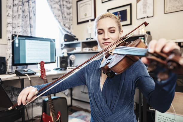 istock Female Musician practising at home 1466478371