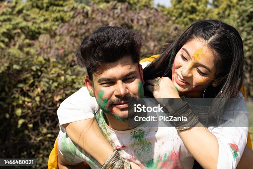 istock A young couple friends family boy girl man woman celebrating enjoying holi festival of colors colours with gulal abeer color powder outdoor in a park, a popular hindu festival celebrated across india 1466480021