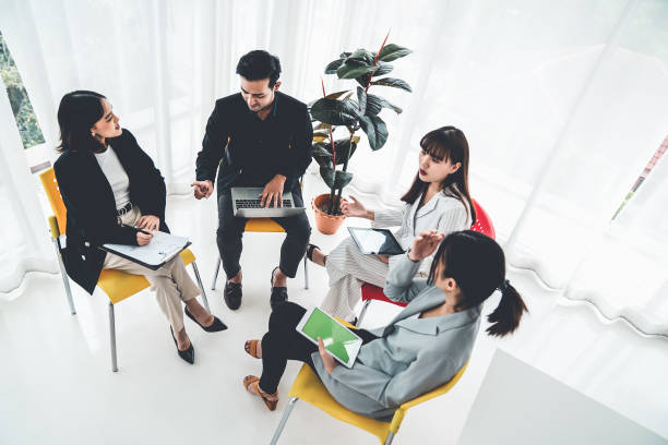 istock Business people proficiently discuss work project while sitting in circle . Corporate business team collaboration concept . 1466480574