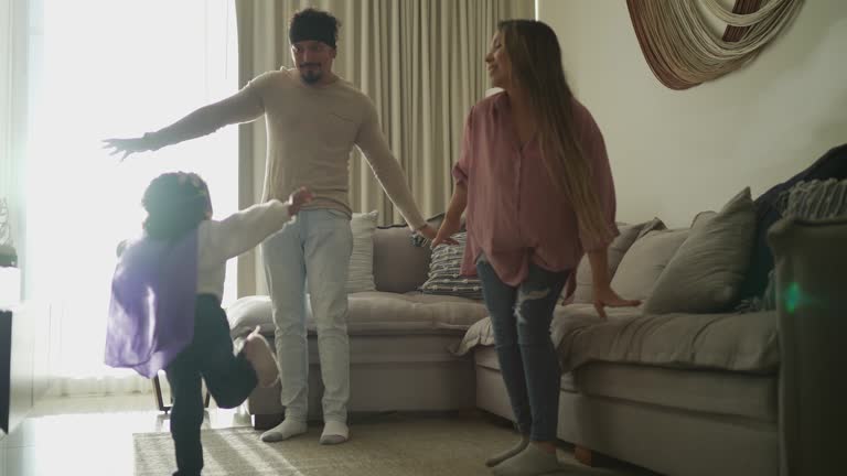 Parents having fun with their daughter in the living room at home