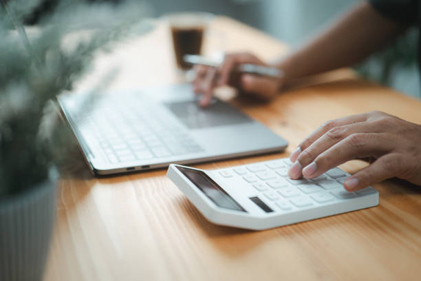istock Hands of an accountant using a calculator to calculate a tax refund 1466481069