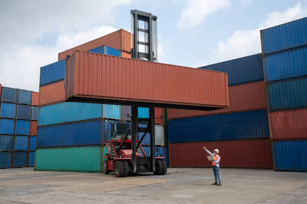 istock Cargo container for overseas shipping in shipyard with heavy machine . Logistics supply chain management and international goods export concept . 1466482886