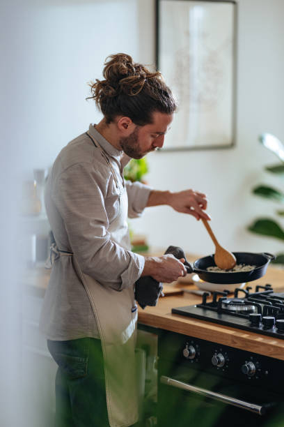 istock Handsome Man Making A Healthy Meal In The Kitchen 1466484385