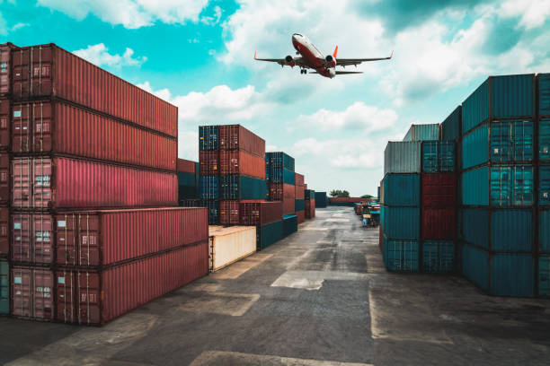 istock Cargo container for overseas shipping in shipyard with airplane in the sky . Logistics supply chain management and international goods export concept . 1466485354