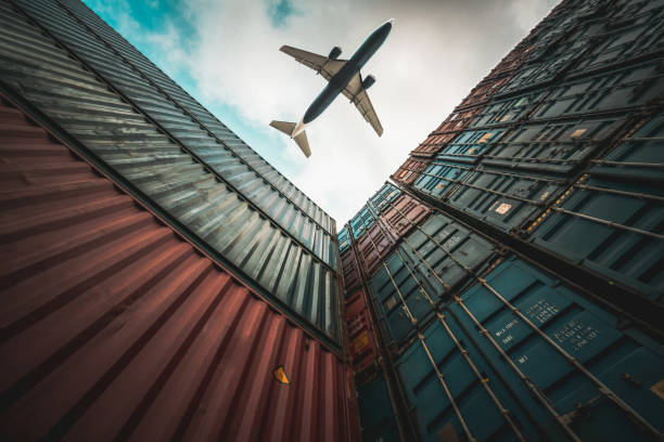 istock Freight airplane flying above overseas shipping container . Logistics supply chain management and international goods export concept . 1466485462