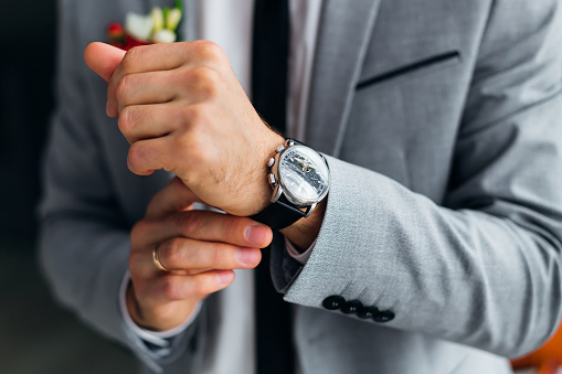 close-up of groom hand with a wristwatch. stylish watch