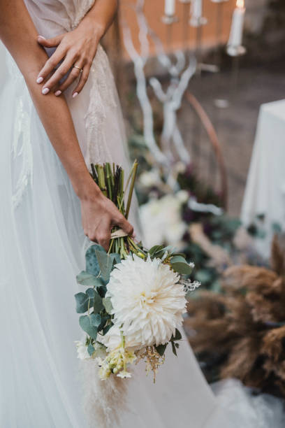 istock Beautiful wedding bouquet in hands of the bride. 1466486309
