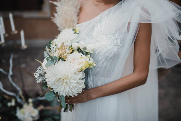 istock Beautiful wedding bouquet in hands of the bride. 1466486352