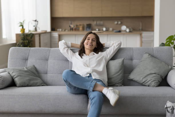 istock Happy girl relaxing on new comfortable sofa at home 1466487825