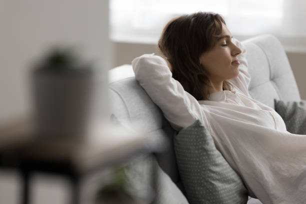 istock Calm pretty young woman resting on cozy sofa 1466487837